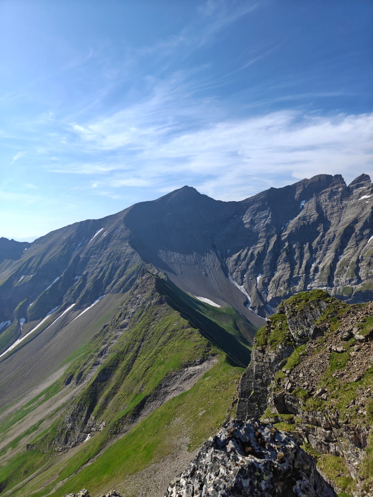Rocky summit ridge with a huge scree bowl visible in the distance