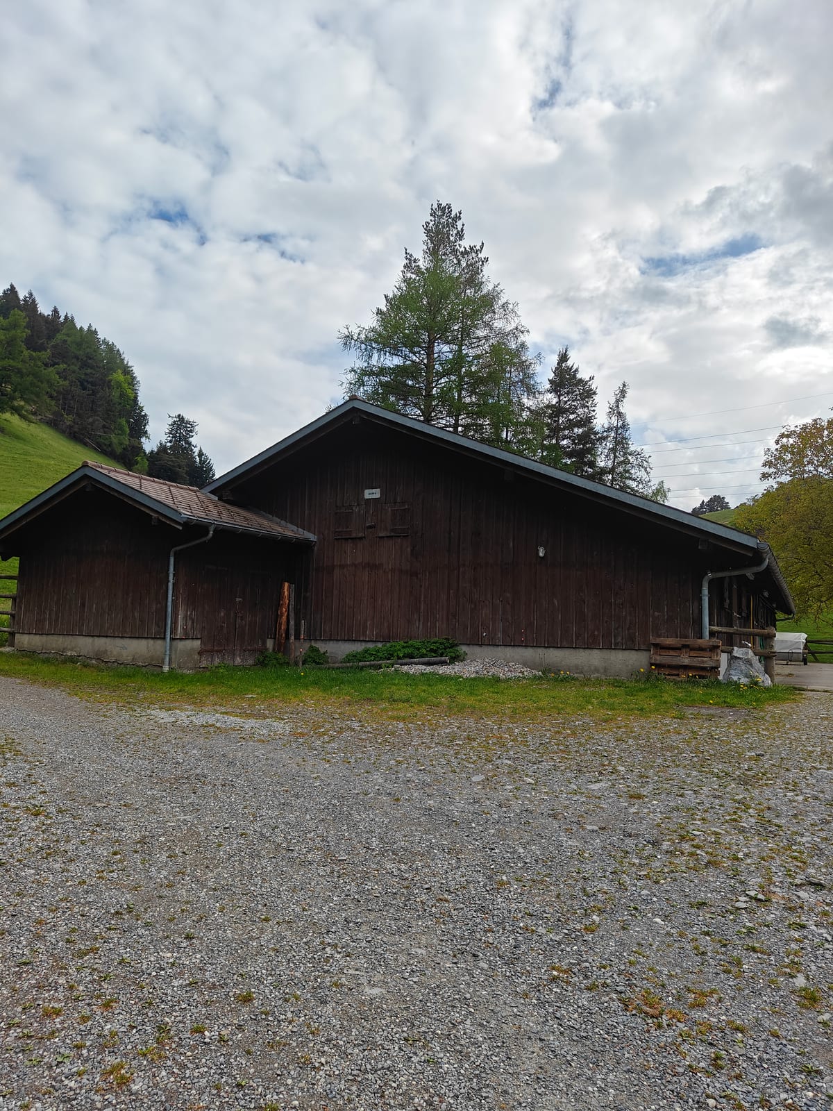The wooden alpine hut at Alp Lida on a gravel terrace