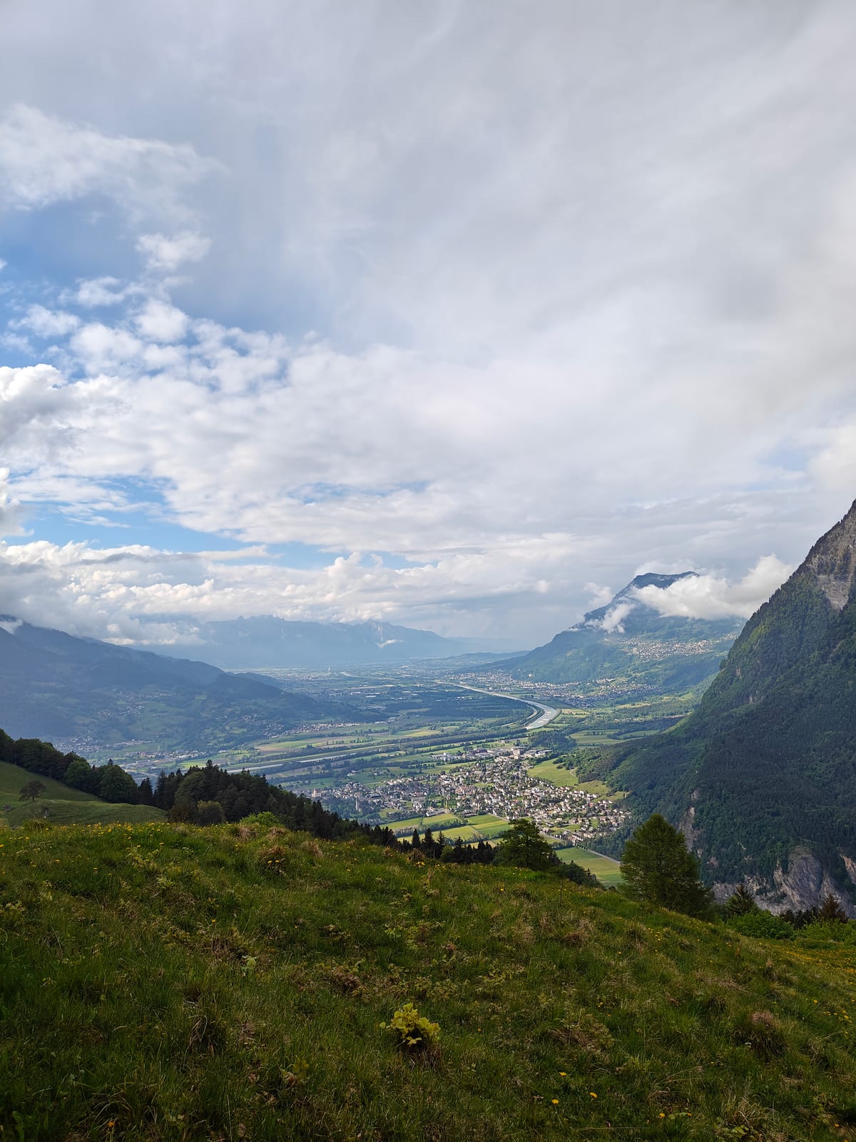 Wide Rhine Valley view with Balzers below and Alps in distance