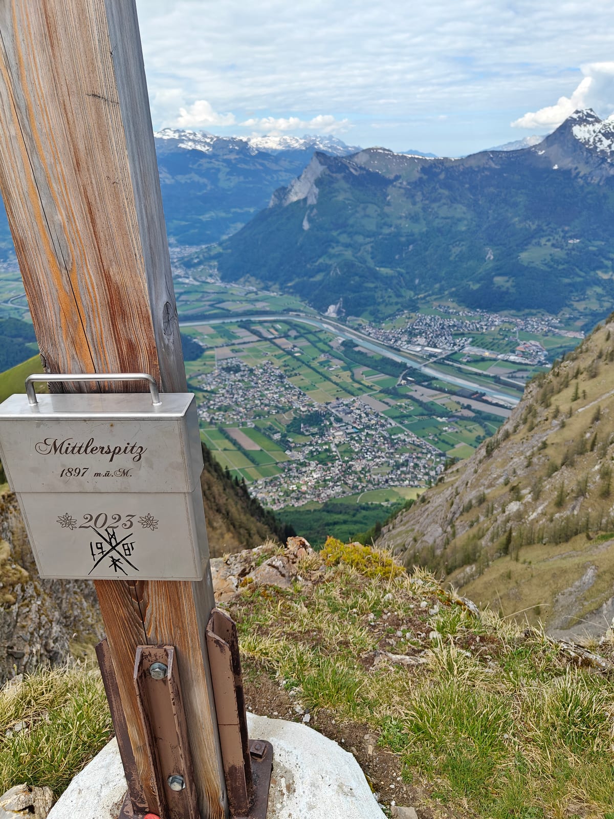 Mittlerspitz summit tin at 1,897m with Rhine Valley and Alps in background