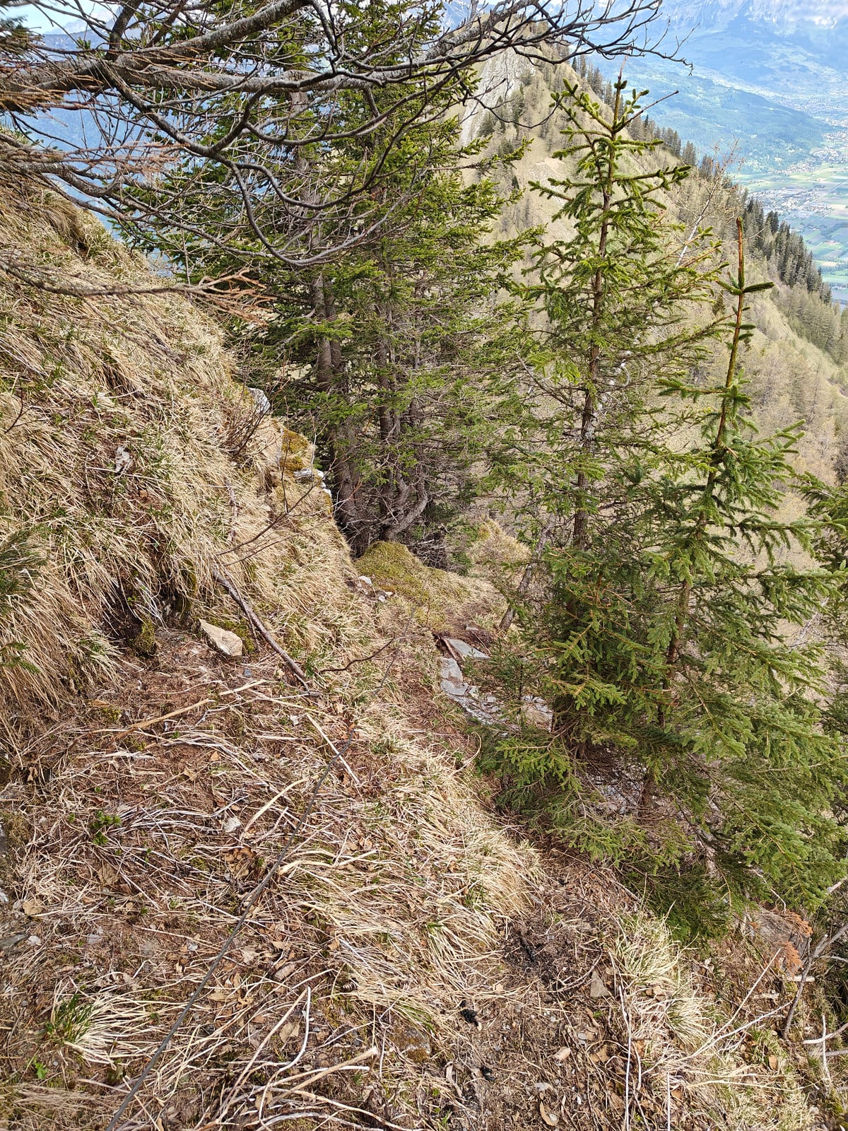 Narrow traverse path along the exposed ridge with steep drop below