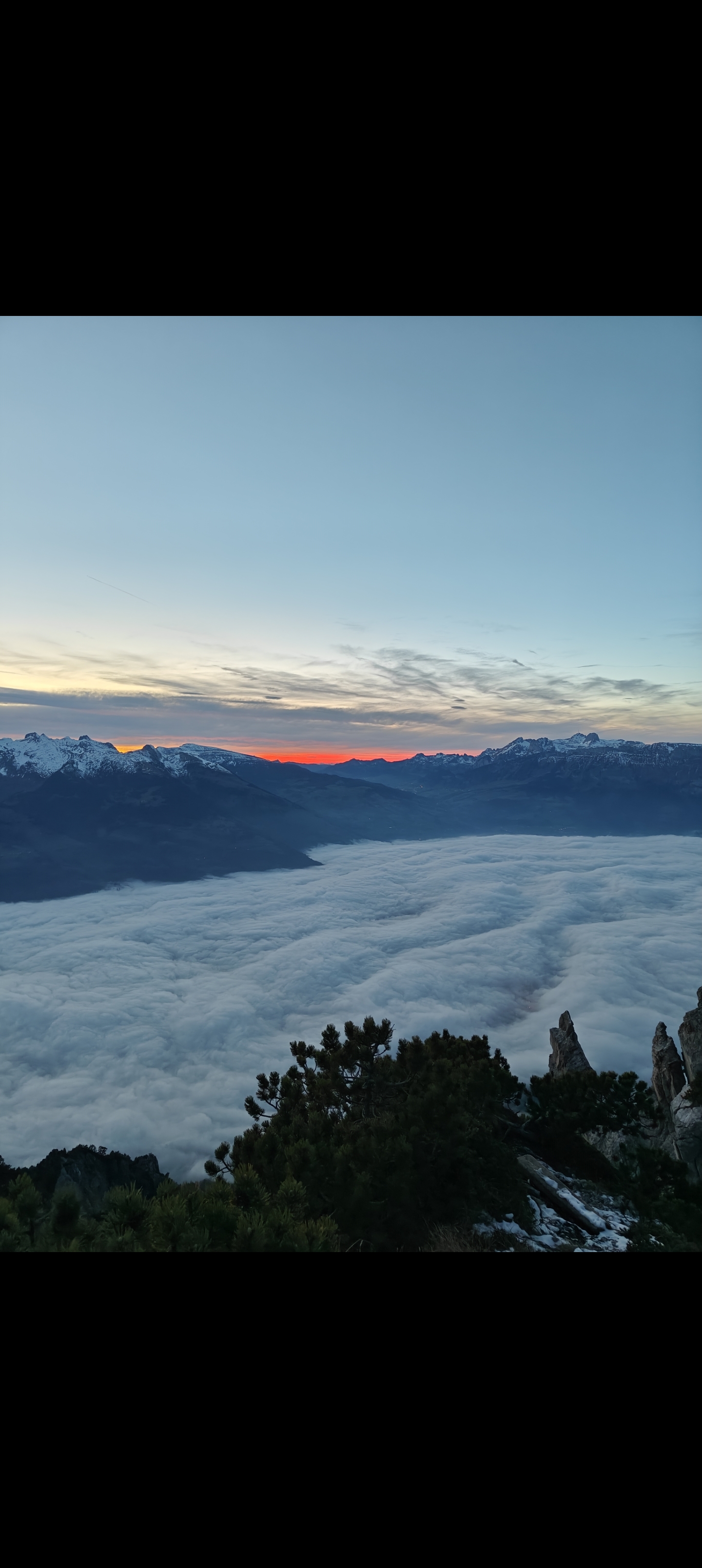 Sea of clouds over the Alps at sunset